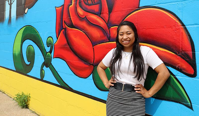 Alma, posing in front of a Cedar Rapids mural